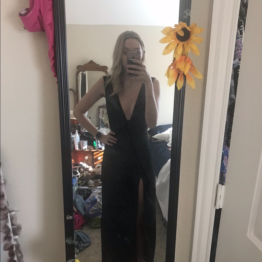 Black low cut dress. Slit on side.